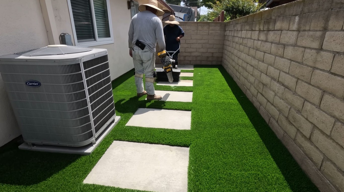 Professional artificial turf installation with paver walkway in Daly City, CA