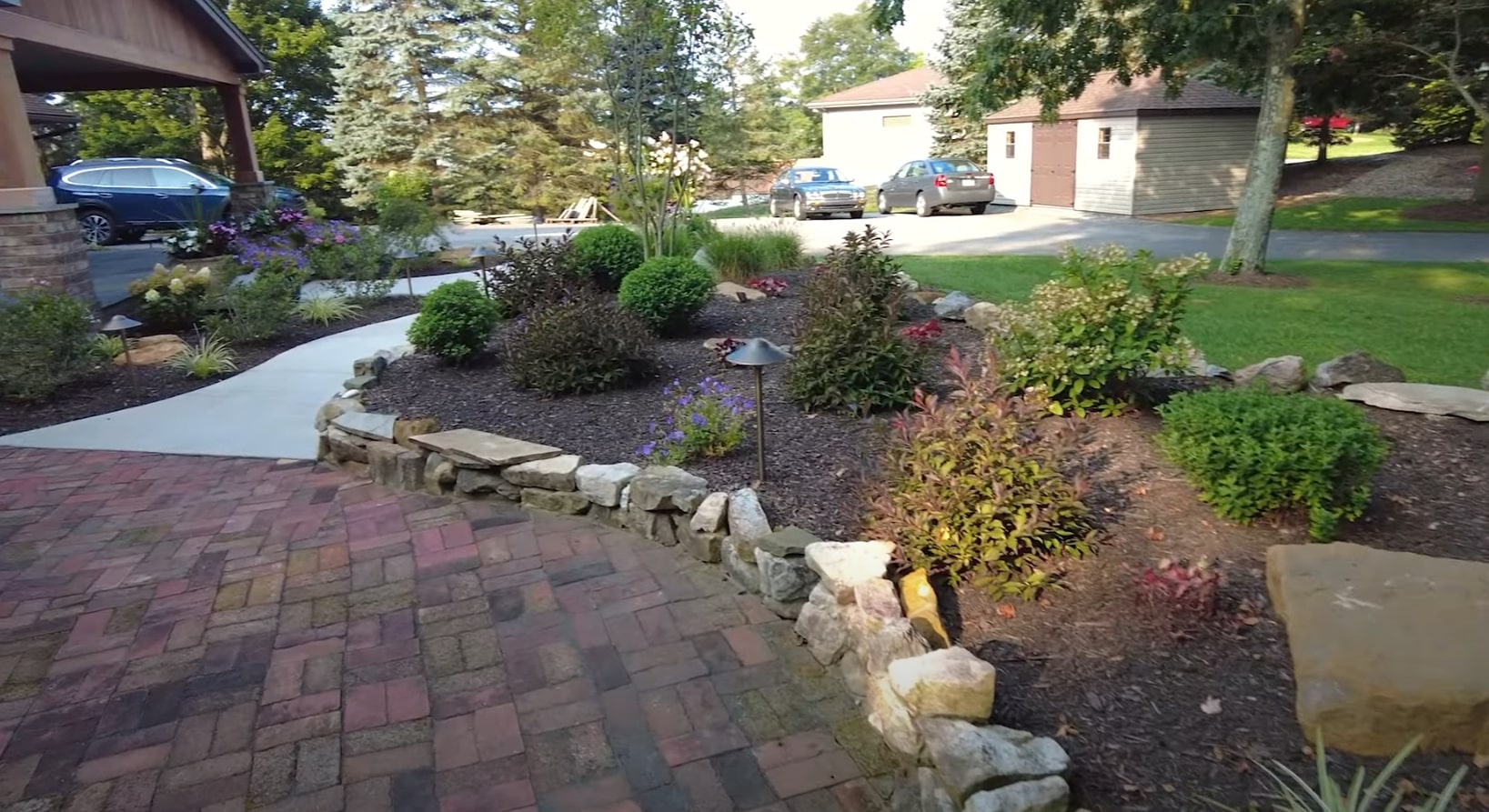 Hardscaping Design - Stone Retaining Walls and Curved Walkways Front yard hardscaping with stone retaining walls, curved walkways, and professional landscape design